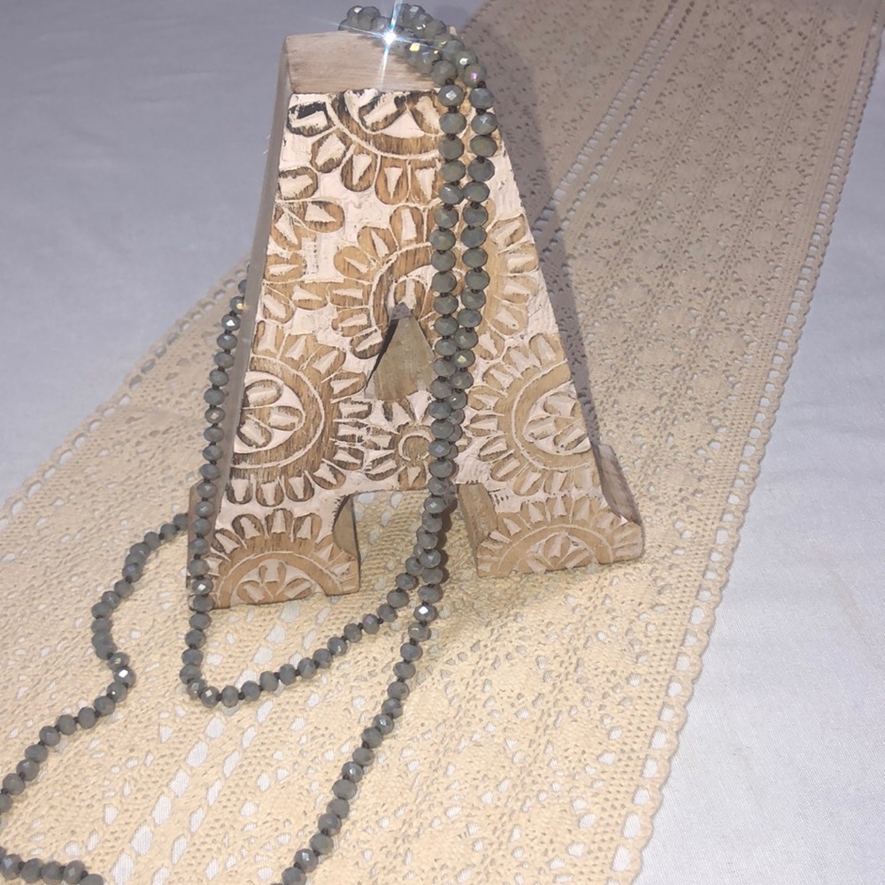 Long strand of silver/gray necklace